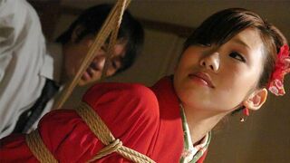 Tied up Asian bimbo sucks two cocks and gets toyed