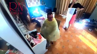 Nudist barbershop. Nude lady hairdresser in an apron. camera. The client is surprised. short 1