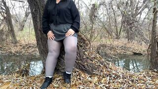 Slutty MILF masturbates her pussy on the river bank at the risk of being seen