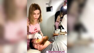 Classy blonde waxes a man's face, her gorgeous breasts popping