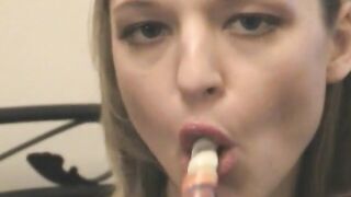 Sucking on a long lollipop