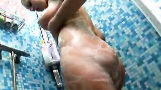 Angelic blond teenage nymphet Amelie washing her big breasts on the shower