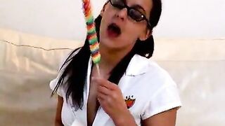 Nerdy amateur British teen babe in pigtails and glasses Poppy licking and sucking a dildo and a lollipop