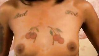 Skinny and tattooed young black girlfriend stripping and showing her assets in bedroom