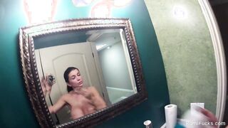 Pornstar Romi Rain plays with her camera in the shower