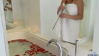 Sexy blonde mom seduces herself in a rose petal bath and uses her fingers to expertly tease her big boobs and dripping wet pussy