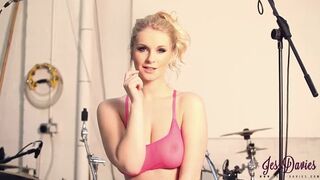 Jess Davies strips by the drum set.